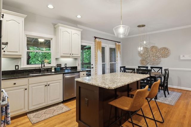 6781 Autumnwood Dr, Nashville, TN 37221 - kitchen featuring stainless steel dishwasher, a sink, a kitchen bar, decorative light fixtures, and a kitchen island