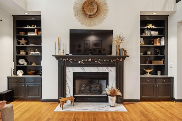 6781 Autumnwood Dr, Nashville, TN 37221 - living room with light wood-style floors, a high end fireplace, and built in features