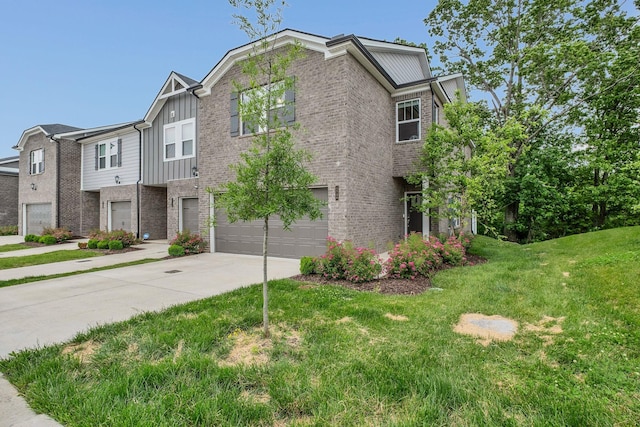 1736 Tahoma Dr, Lebanon, TN 37087 - view of front of property with driveway, brick siding, board and batten siding, an attached garage, and a front yard