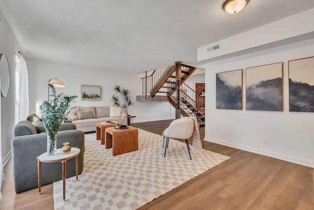 4001 Anderson Rd Unit F68, Nashville, TN 37217 - living room featuring stairway, a textured ceiling, wood finished floors, and baseboards