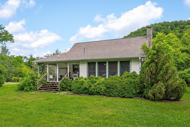 3975 Dry Creek Rd, Dowelltown, TN 37059 - view of front of home with a front lawn, a chimney, and covered porch