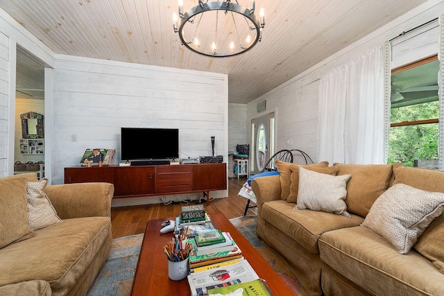 3975 Dry Creek Rd, Dowelltown, TN 37059 - living room featuring dark wood-style floors, a chandelier, wooden ceiling, and concrete block wall