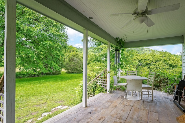 3975 Dry Creek Rd, Dowelltown, TN 37059 - deck featuring a yard, a ceiling fan, outdoor dining space, and view of wooded area