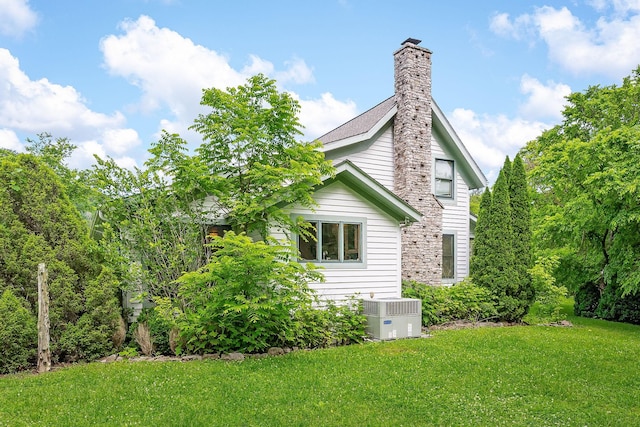 3975 Dry Creek Rd, Dowelltown, TN 37059 - view of side of home featuring central AC, a yard, and a chimney