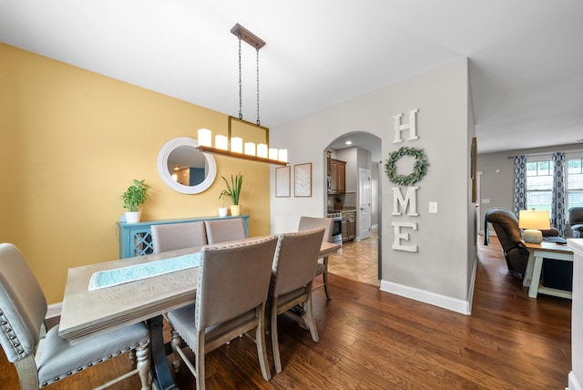 2157 Christina Ct, Hermitage, TN 37076 - dining room featuring arched walkways, dark wood finished floors, and baseboards