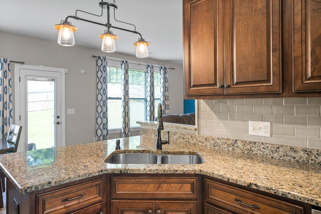 2157 Christina Ct, Hermitage, TN 37076 - kitchen with a sink, backsplash, light stone counters, and decorative light fixtures