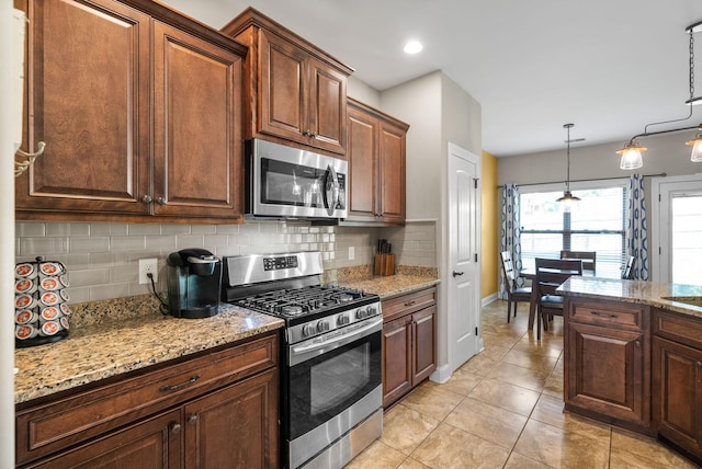 2157 Christina Ct, Hermitage, TN 37076 - kitchen featuring appliances with stainless steel finishes, baseboards, tasteful backsplash, light stone countertops, and light tile patterned flooring