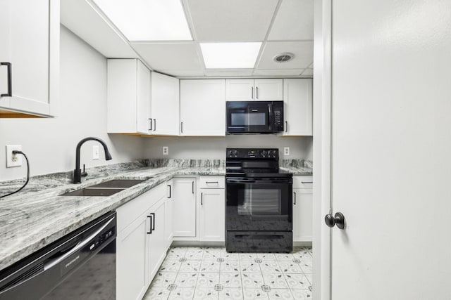 210 Old Hickory Blvd Unit 42, Nashville, TN 37221 - kitchen with black appliances, a sink, a paneled ceiling, white cabinetry, and light stone counters