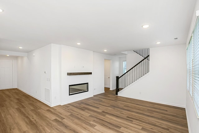 2368 Williamsport Lndg, Columbia, TN 38401 - unfurnished living room with wood finished floors, stairway, recessed lighting, baseboards, and plenty of natural light