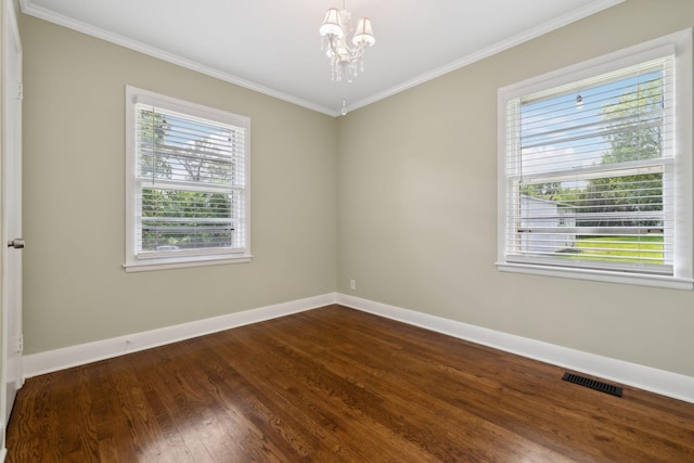 510 Bismark Dr, Nashville, TN 37210 - empty room featuring a chandelier, baseboards, dark wood-style floors, and crown molding