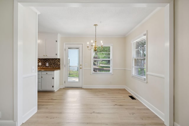 510 Bismark Dr, Nashville, TN 37210 - unfurnished dining area with crown molding, a chandelier, light wood finished floors, and baseboards