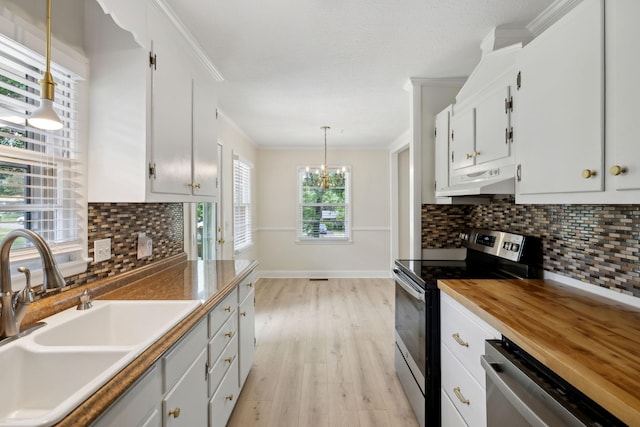 510 Bismark Dr, Nashville, TN 37210 - kitchen featuring stainless steel appliances, a sink, under cabinet range hood, light wood-style floors, and crown molding