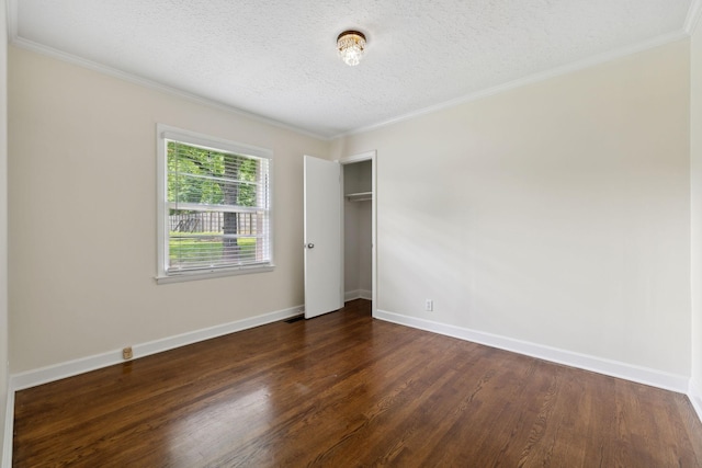 510 Bismark Dr, Nashville, TN 37210 - unfurnished bedroom with dark wood finished floors, a textured ceiling, ornamental molding, a closet, and baseboards