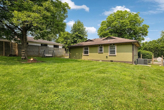 510 Bismark Dr, Nashville, TN 37210 - rear view of house featuring central AC, a fire pit, and brick siding