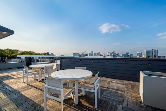 806 Olympic St Unit 305, Nashville, TN 37203 - wooden terrace with outdoor dining area and a skyline view