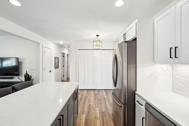 304 Jenny Murff Dr, Antioch, TN 37013 - kitchen featuring stainless steel appliances, light wood finished floors, decorative backsplash, recessed lighting, and pendant lighting