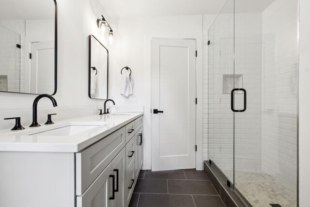 304 Jenny Murff Dr, Antioch, TN 37013 - bathroom with a stall shower, double vanity, and tile patterned floors