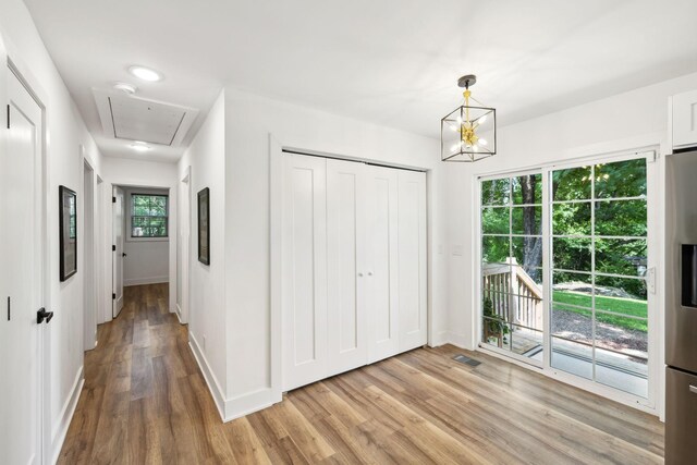 304 Jenny Murff Dr, Antioch, TN 37013 - corridor with attic access, light wood finished floors, baseboards, and a chandelier