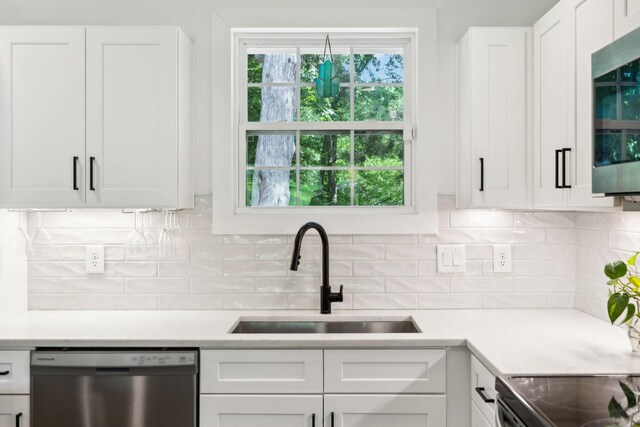 304 Jenny Murff Dr, Antioch, TN 37013 - kitchen featuring appliances with stainless steel finishes, a sink, white cabinets, and light countertops