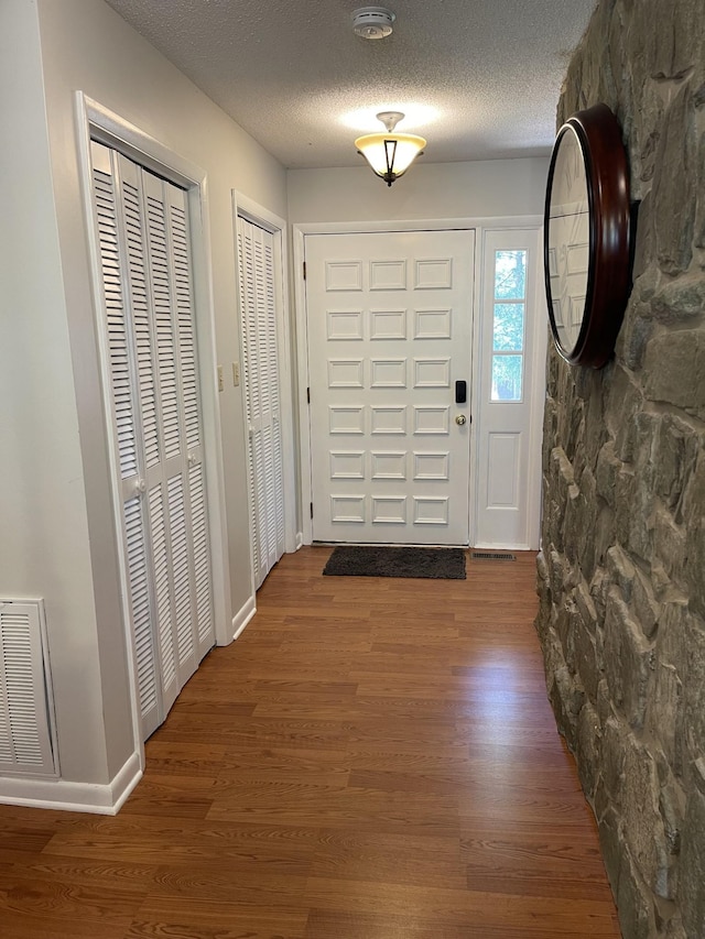 464 Loop Dr, Winchester, TN 37398 - foyer entrance featuring wood finished floors, a textured ceiling, and baseboards