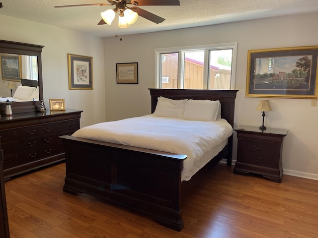 464 Loop Dr, Winchester, TN 37398 - bedroom featuring wood finished floors, multiple windows, a textured ceiling, and a ceiling fan
