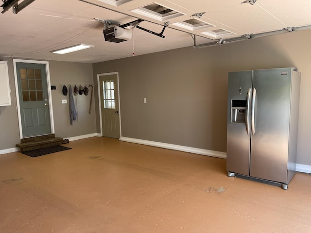 464 Loop Dr, Winchester, TN 37398 - garage with stainless steel refrigerator with ice dispenser, a garage door opener, and baseboards