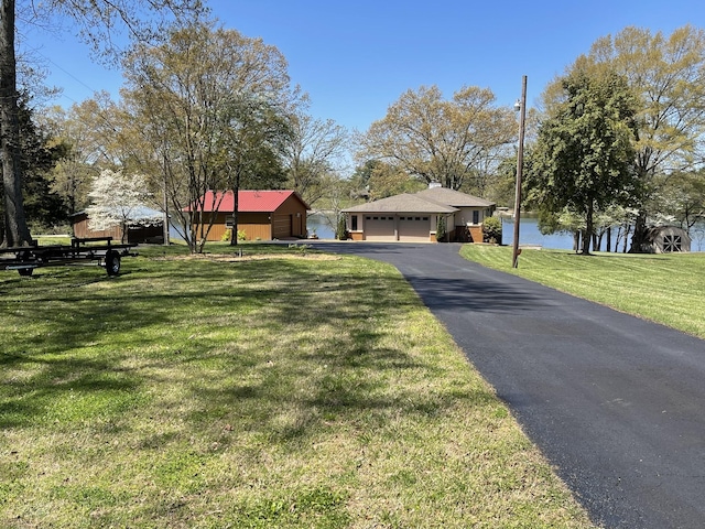 464 Loop Dr, Winchester, TN 37398 - single story home with a front yard, asphalt driveway, a water view, and a garage