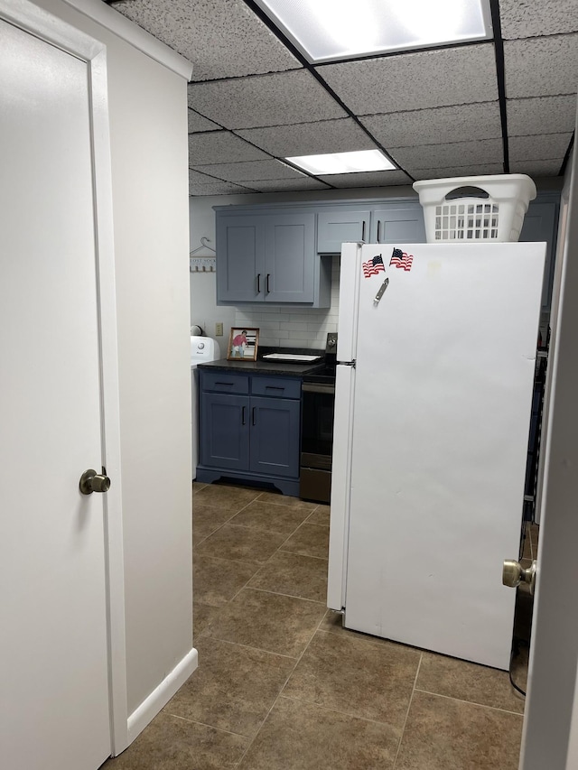 464 Loop Dr, Winchester, TN 37398 - kitchen featuring freestanding refrigerator, stainless steel electric range, dark countertops, dark tile patterned floors, and a drop ceiling