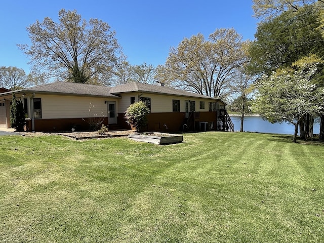 464 Loop Dr, Winchester, TN 37398 - back of house featuring a lawn, a water view, and an attached garage