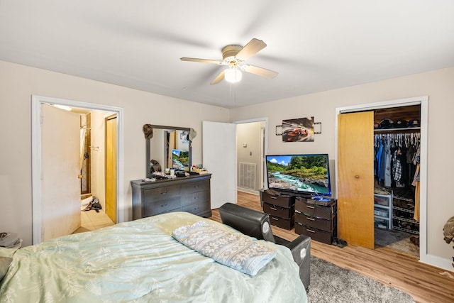 333 Cubbins Hollow Rd, Dowelltown, TN 37059 - bedroom featuring wood finished floors, a closet, ceiling fan, a walk in closet, and connected bathroom
