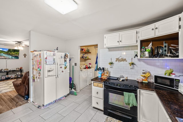 333 Cubbins Hollow Rd, Dowelltown, TN 37059 - kitchen with black appliances, independent washer and dryer, dark countertops, white cabinetry, and tasteful backsplash