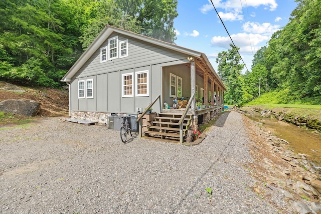 333 Cubbins Hollow Rd, Dowelltown, TN 37059 - view of front facade with board and batten siding and a wooden deck