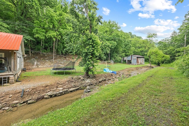 333 Cubbins Hollow Rd, Dowelltown, TN 37059 - view of green lawn with a trampoline