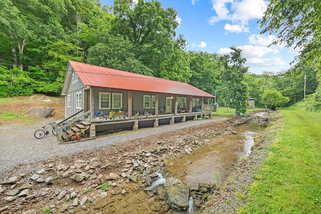 333 Cubbins Hollow Rd, Dowelltown, TN 37059 - view of front of home featuring metal roof, a wooded view, and a porch