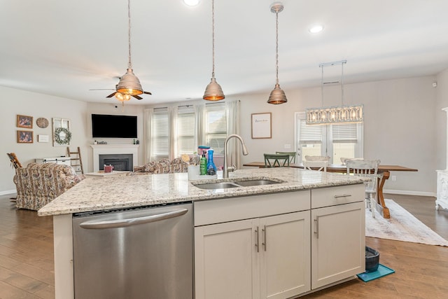 6531 Tulip Tree Dr, Murfreesboro, TN 37128 - kitchen with stainless steel dishwasher, a sink, ceiling fan, a fireplace, and wood finished floors
