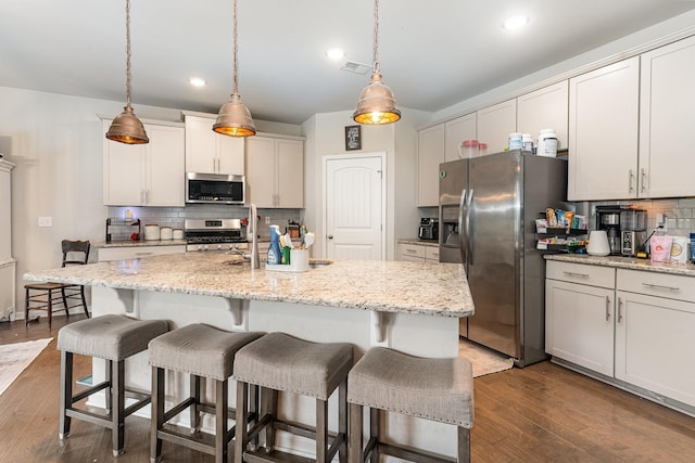 6531 Tulip Tree Dr, Murfreesboro, TN 37128 - kitchen with appliances with stainless steel finishes, backsplash, a breakfast bar, dark wood-style flooring, and decorative light fixtures