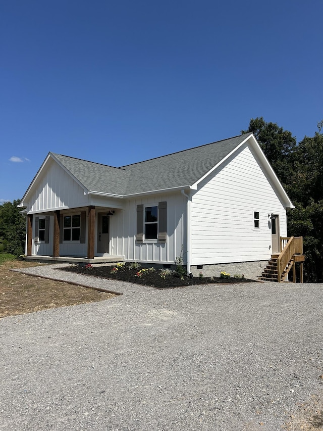 5708 Little Dry Creek Rd, Pulaski, TN 38478 - view of front facade with driveway, a shingled roof, a porch, crawl space, and board and batten siding
