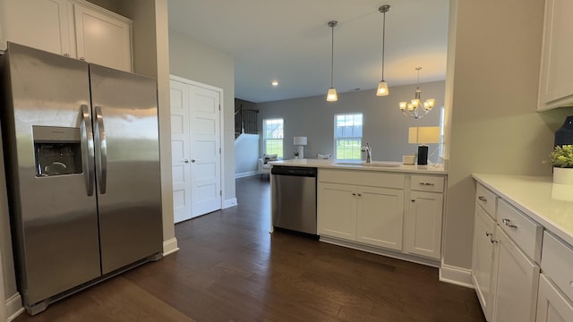 881 Meadowcrest Way, Lebanon, TN 37090 - kitchen featuring appliances with stainless steel finishes, dark wood-style floors, white cabinetry, light countertops, and a chandelier
