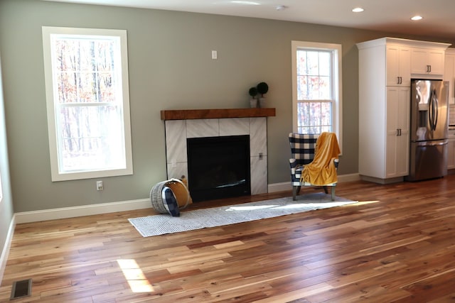 2420 Eagle Rock Rd, Monteagle, TN 37356 - unfurnished living room featuring hardwood / wood-style floors, baseboards, recessed lighting, and a tiled fireplace