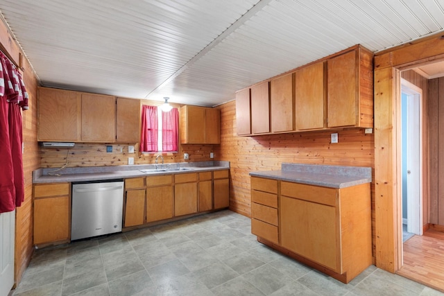 208 S Russell St, Portland, TN 37148 - kitchen featuring dishwasher, a sink, wooden walls, brown cabinets, and light countertops