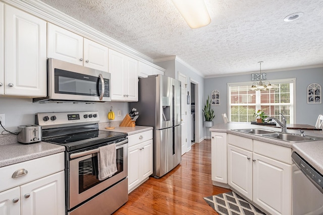 5026 Claude Dr, Smyrna, TN 37167 - kitchen with appliances with stainless steel finishes, a sink, ornamental molding, light wood-type flooring, and white cabinets