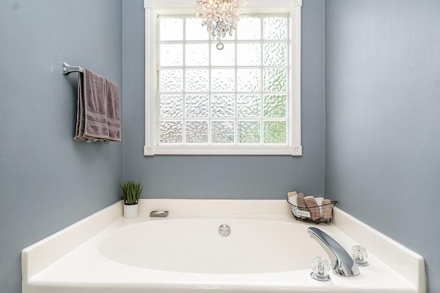 5026 Claude Dr, Smyrna, TN 37167 - bathroom featuring a bath and a chandelier