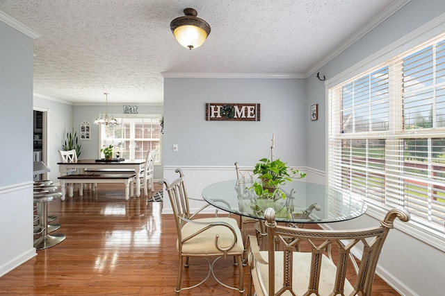 5026 Claude Dr, Smyrna, TN 37167 - dining space featuring a textured ceiling, wood finished floors, ornamental molding, a chandelier, and baseboards
