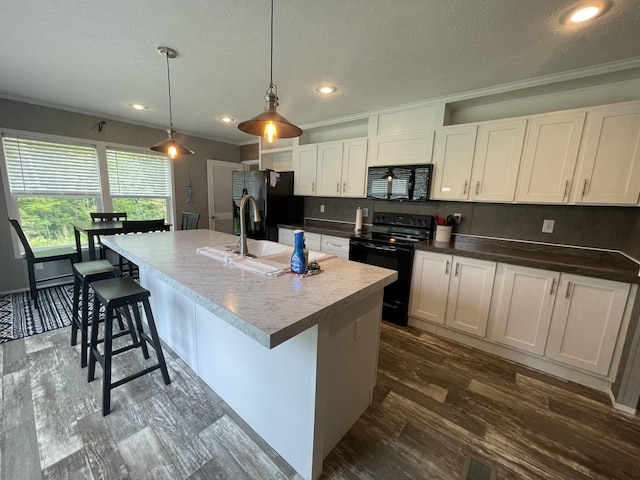 454 Slater Loop, Pikeville, TN 37367 - kitchen featuring black appliances, ornamental molding, a sink, a center island with sink, and dark wood-type flooring