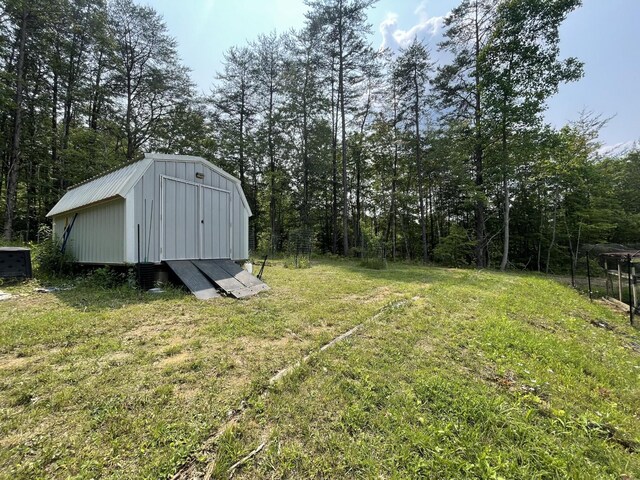 454 Slater Loop, Pikeville, TN 37367 - view of green lawn featuring central air condition unit and a wooded view
