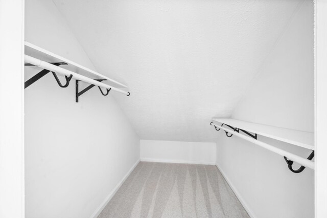 2210 Falcon Creek Dr, Franklin, TN 37067 - spacious closet featuring lofted ceiling and light carpet