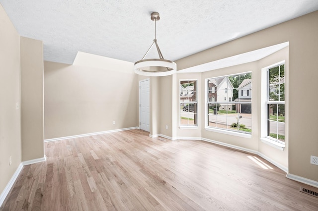 2210 Falcon Creek Dr, Franklin, TN 37067 - unfurnished dining area featuring light wood-style floors, a textured ceiling, and baseboards