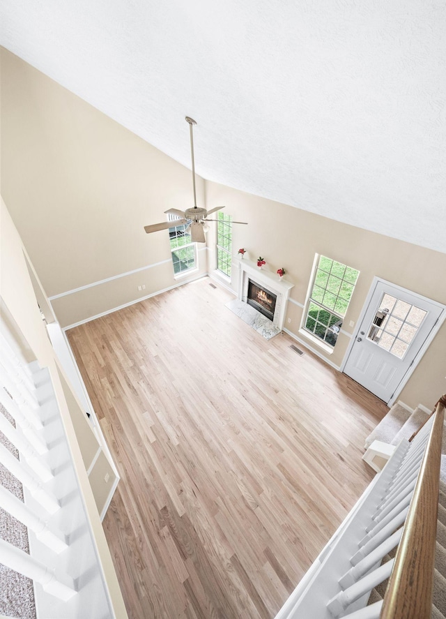 2210 Falcon Creek Dr, Franklin, TN 37067 - unfurnished living room featuring wood finished floors, a ceiling fan, baseboards, vaulted ceiling, and stairway