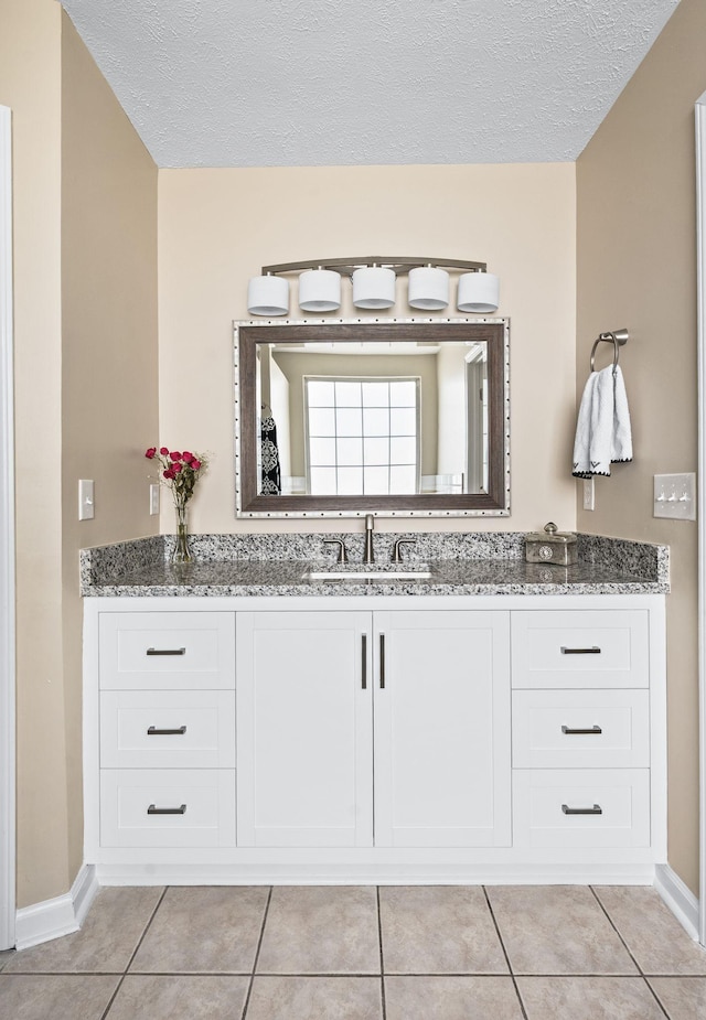 2210 Falcon Creek Dr, Franklin, TN 37067 - bathroom featuring tile patterned floors, vanity, a textured ceiling, and baseboards