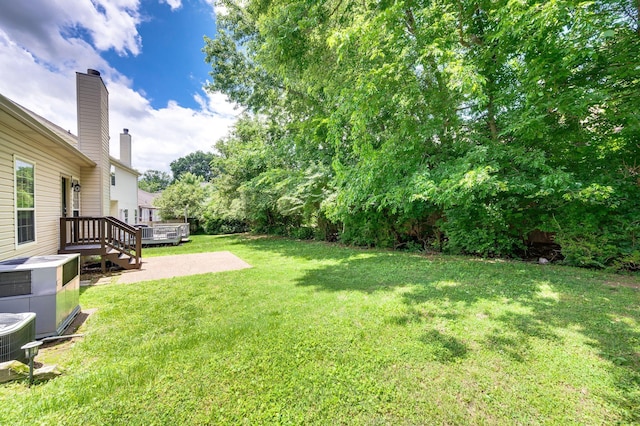 2210 Falcon Creek Dr, Franklin, TN 37067 - view of grassy yard featuring cooling unit and a wooden deck